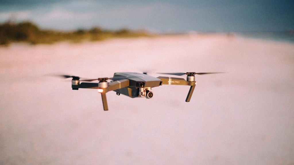 DJI Inspire 3 hovering over a coastal skyline at golden hour